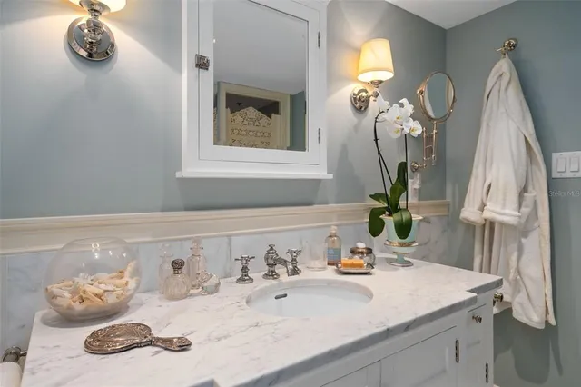 a bathroom with a sink and a mirror