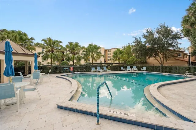 a swimming pool with outdoor seating and yard