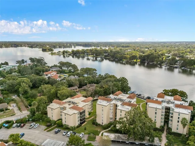 an aerial view of a house with outdoor space and lake view
