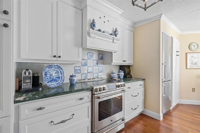 a kitchen with stainless steel appliances granite countertop a sink and a stove