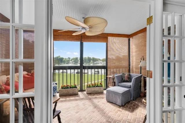 a bedroom with furniture and a large window