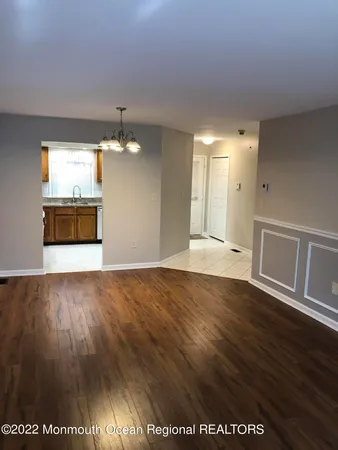 a view of a room with wooden floor and staircase