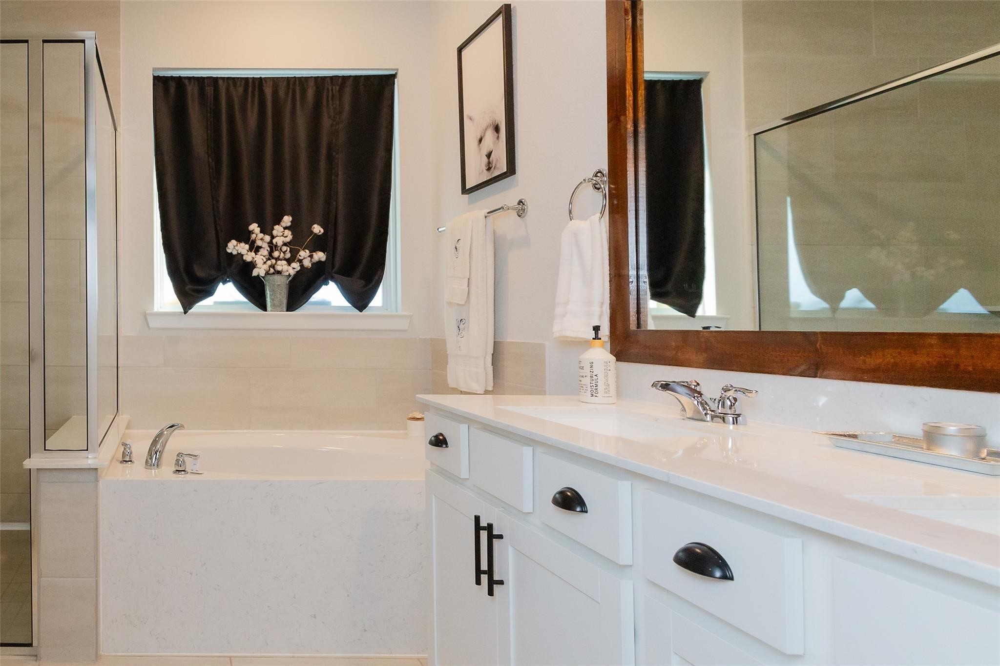 385 Weimer Lagoon Road La Porte, TX 77571 - Photo 12 of 22 This bathroom features a clean, modern design with a large soaking tub, separate shower, and double vanity with polished fixtures.