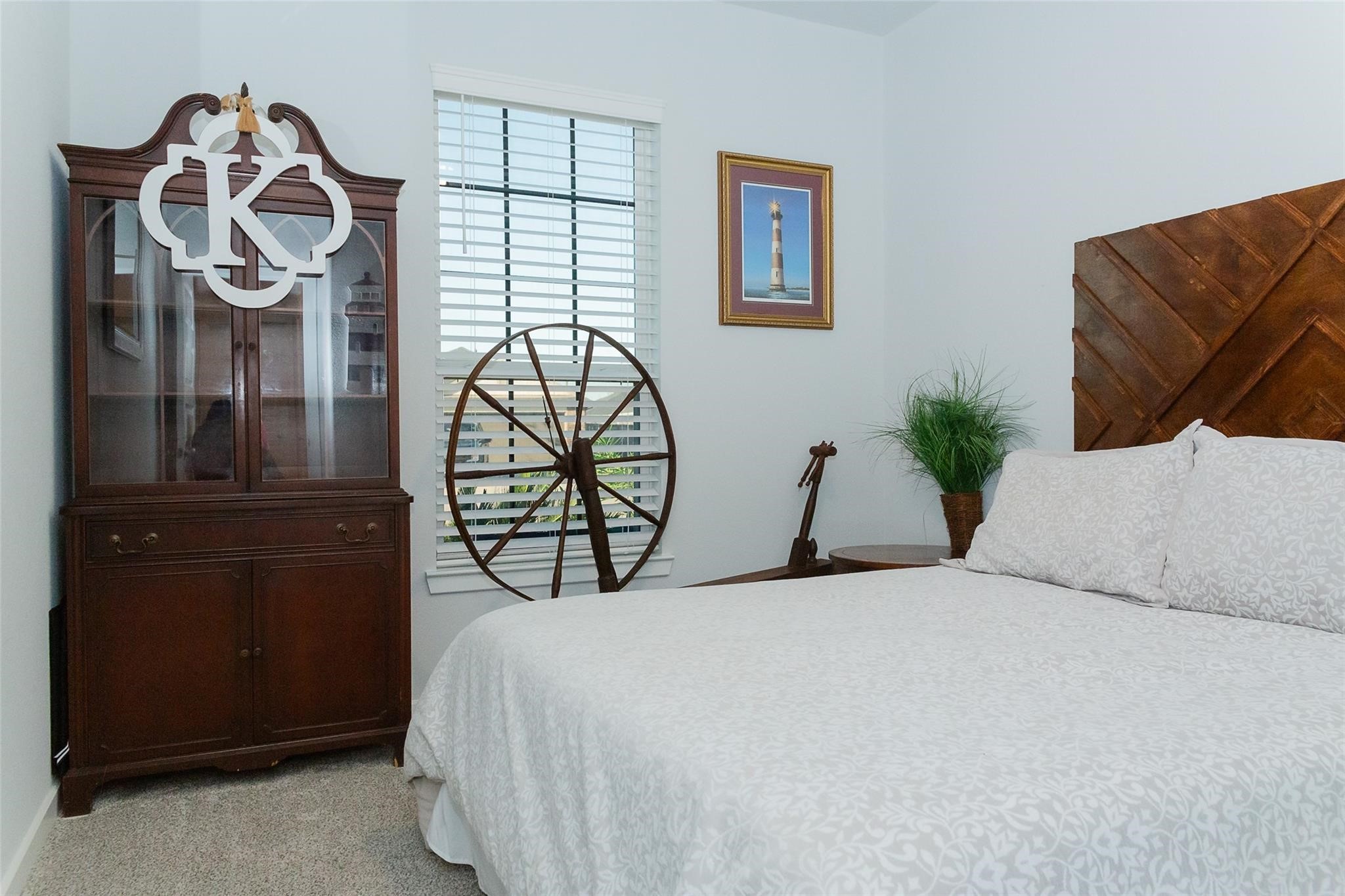 385 Weimer Lagoon Road La Porte, TX 77571 - Photo 14 of 22 a bedroom with a bed and a chandelier
