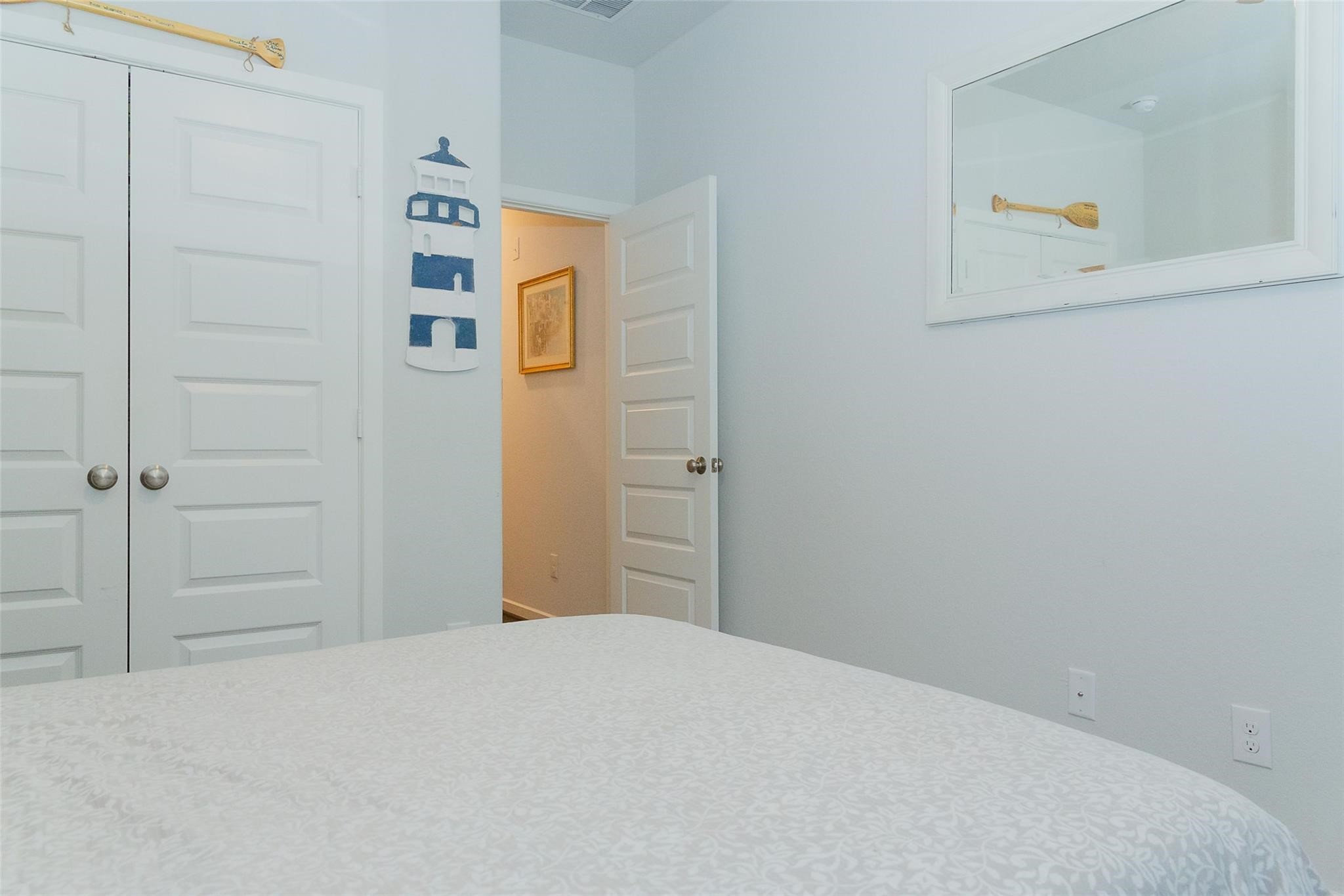 385 Weimer Lagoon Road La Porte, TX 77571 - Photo 16 of 22 a bedroom with a bed and cupboard