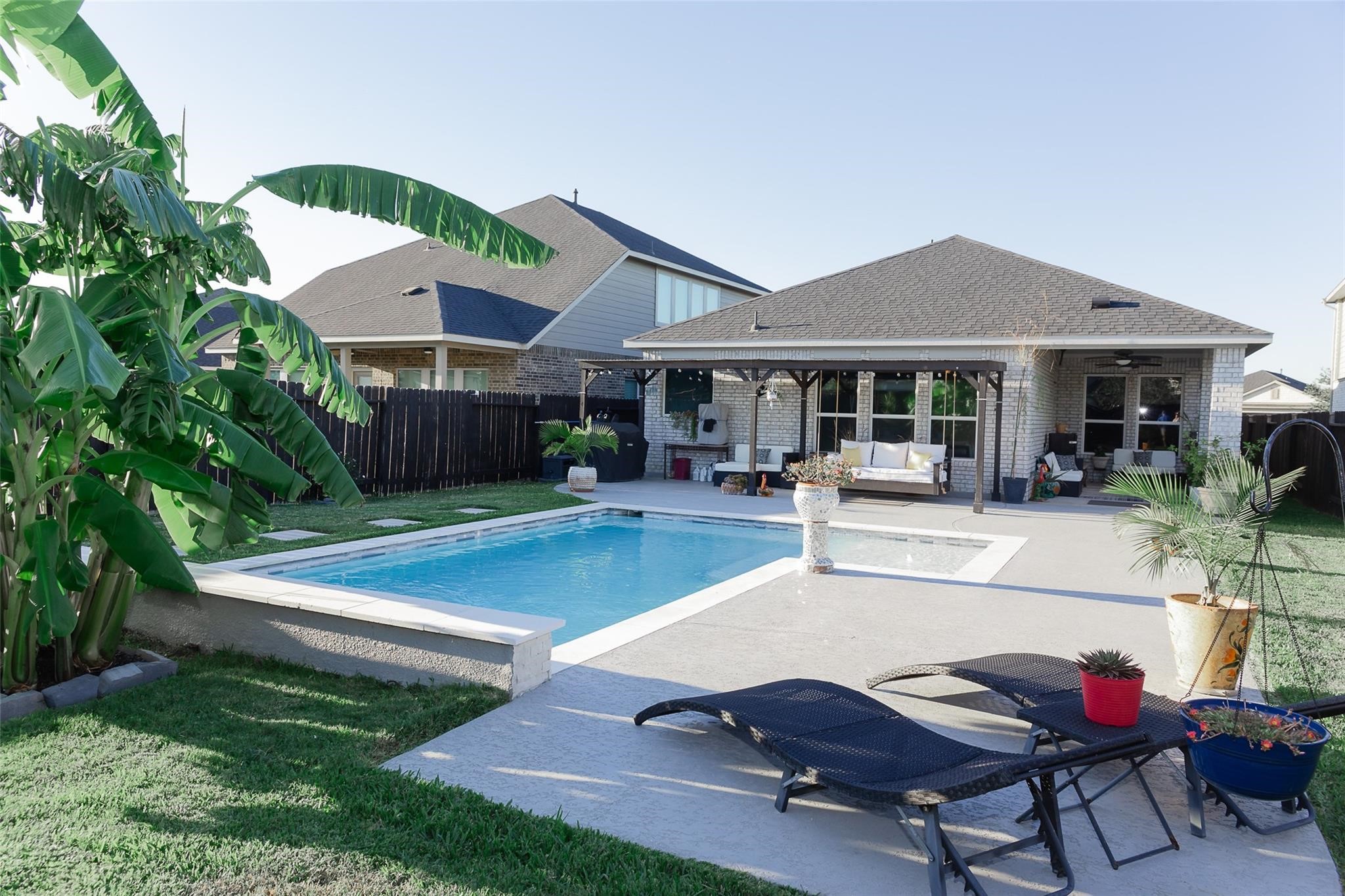 385 Weimer Lagoon Road La Porte, TX 77571 - Photo 20 of 22 This photo showcases a charming backyard with a pool and spacious patio area, perfect for relaxation and entertaining.