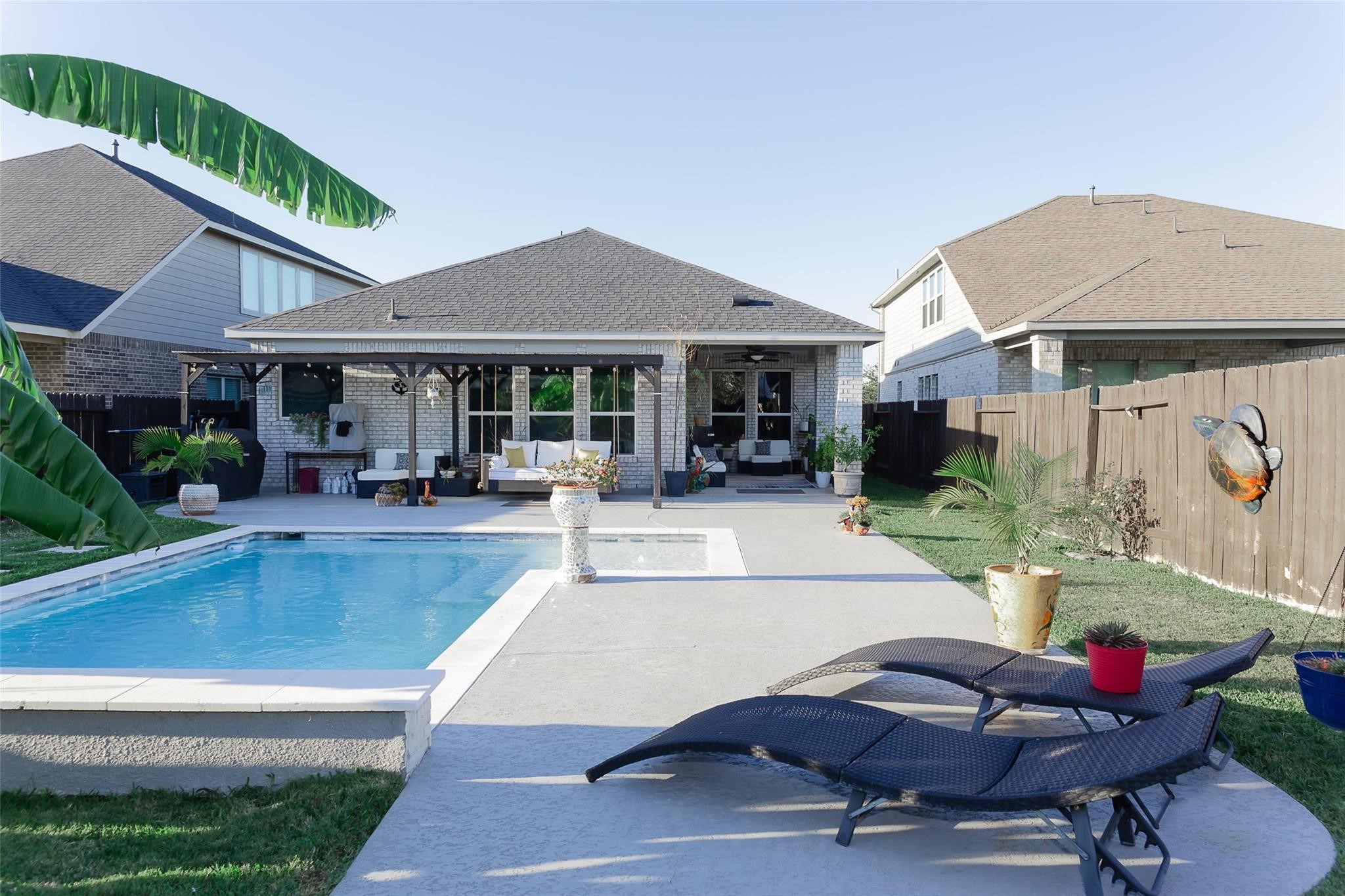 385 Weimer Lagoon Road La Porte, TX 77571 - Photo 21 of 22 a view of a patio with table and chairs potted plants and a large tree