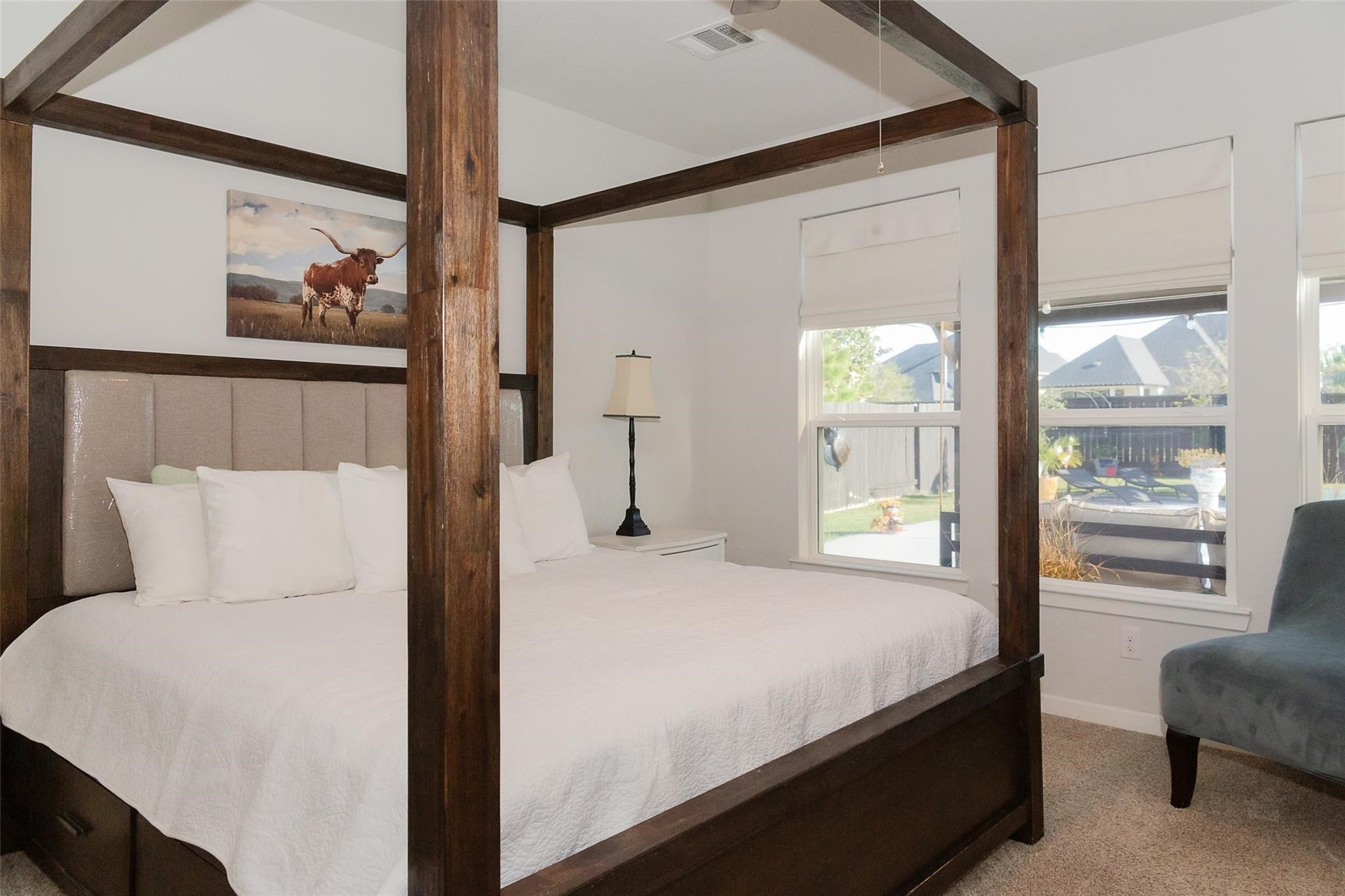 385 Weimer Lagoon Road La Porte, TX 77571 - Photo 9 of 22 This bedroom is complemented by natural light from large windows. An outdoor view creates a tranquil atmosphere.