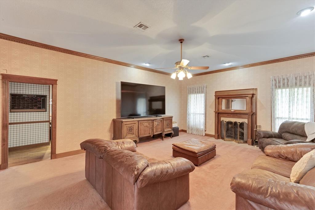 2717 Clear Lake Road Weatherford, TX 76087 - Photo 9 of 40 Living space featuring a prominent decorative fireplace with a wood mantel