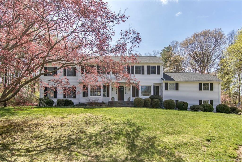 128 Deer Run Road Wilton, CT 06897 - Photo 1 of 1 a front view of a house with a yard and trees