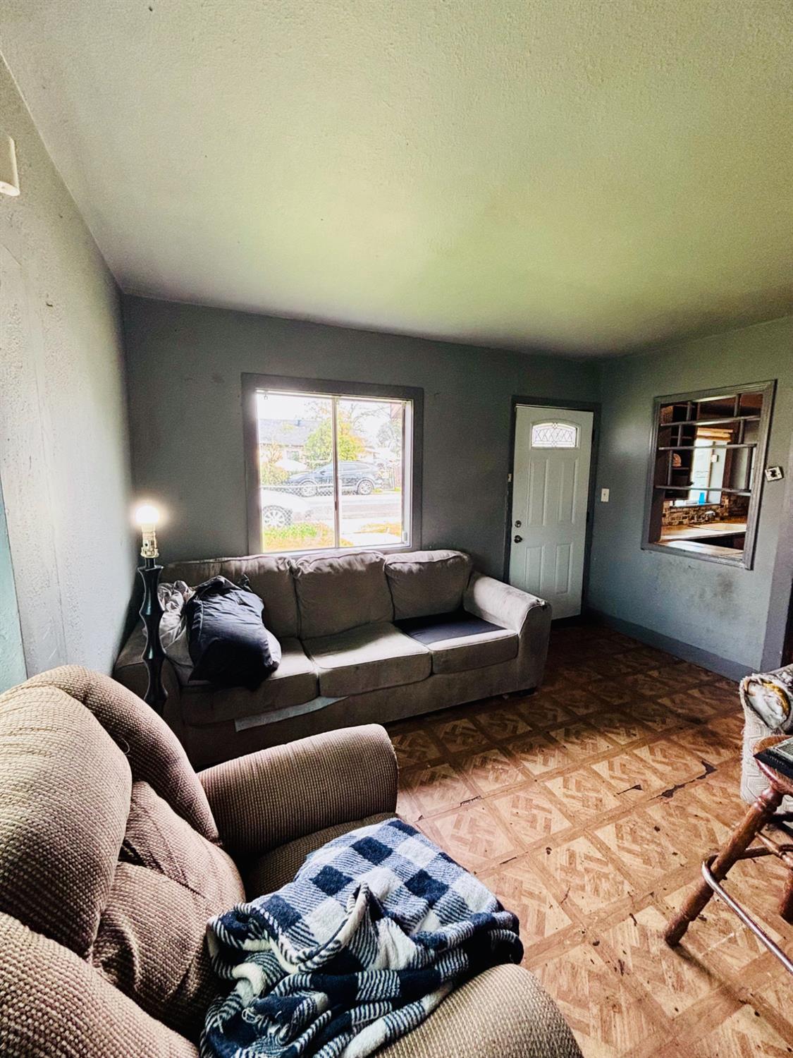 1141 E Street Stockton, CA 95205 - Photo 3 of 13 a living room with furniture and a window