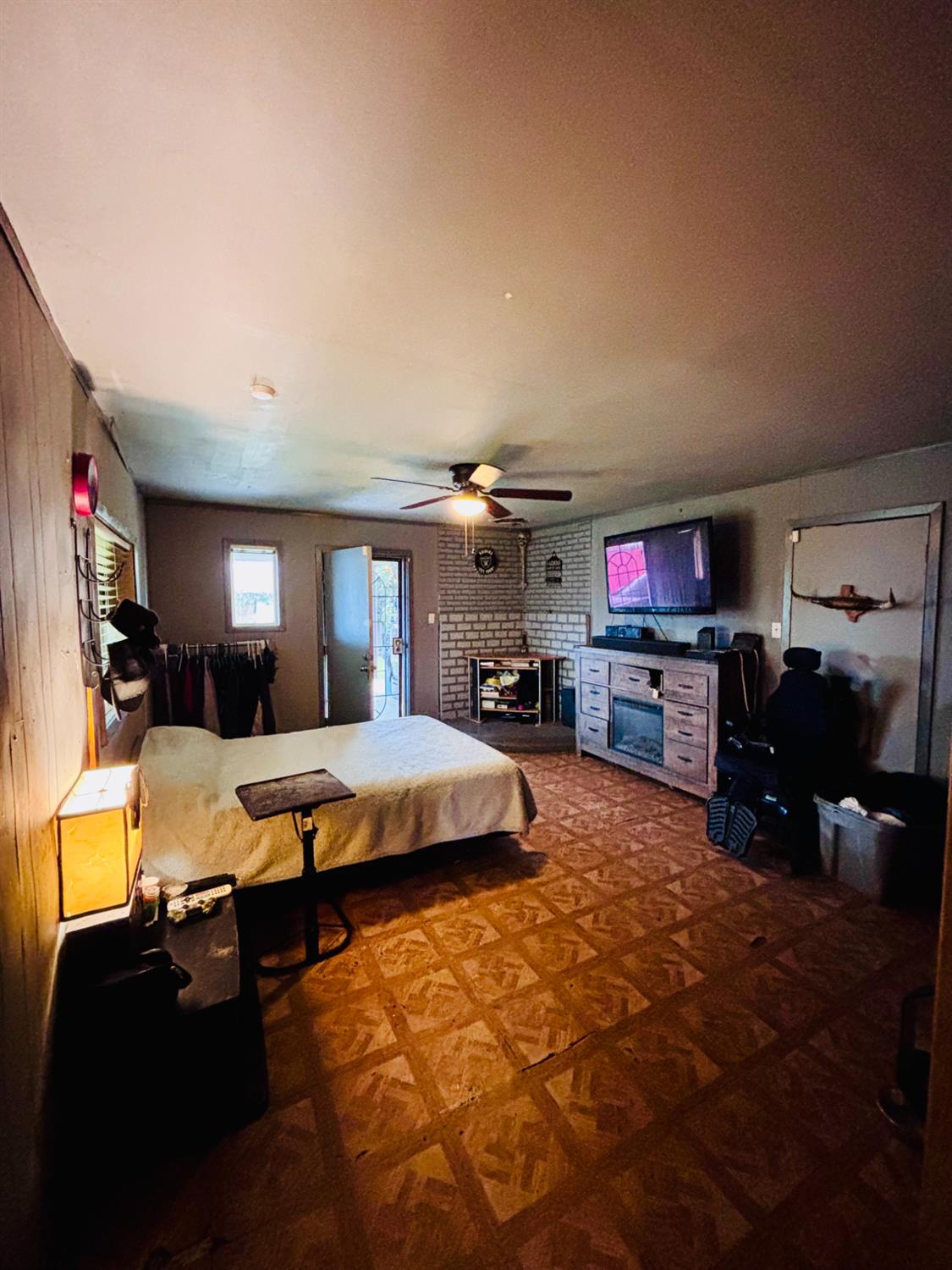 1141 E Street Stockton, CA 95205 - Photo 5 of 13 a bedroom with furniture and a flat screen tv