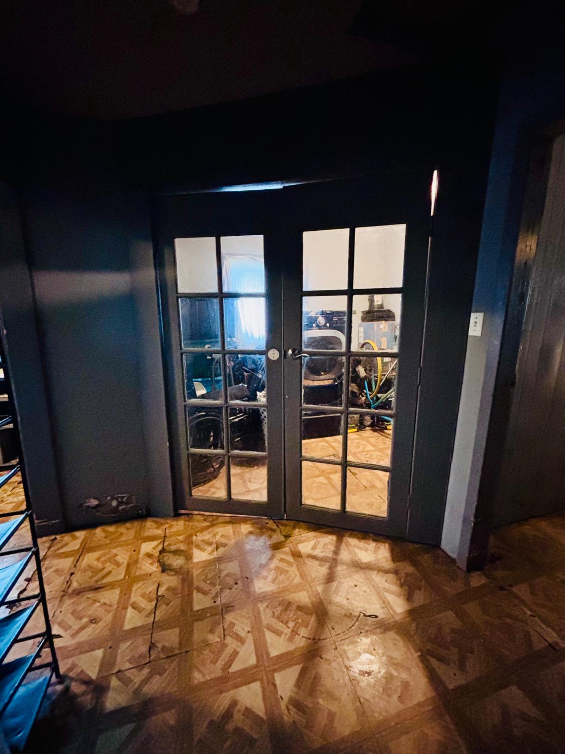 1141 E Street Stockton, CA 95205 - Photo 8 of 13 a view of an empty room with floor to ceiling window and wooden floor