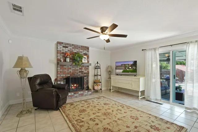 a living room with furniture a fireplace and a flat screen tv