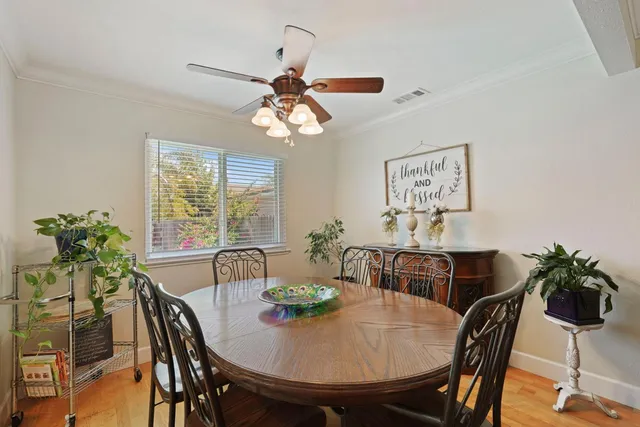 a view of a dining room with furniture and chandelier