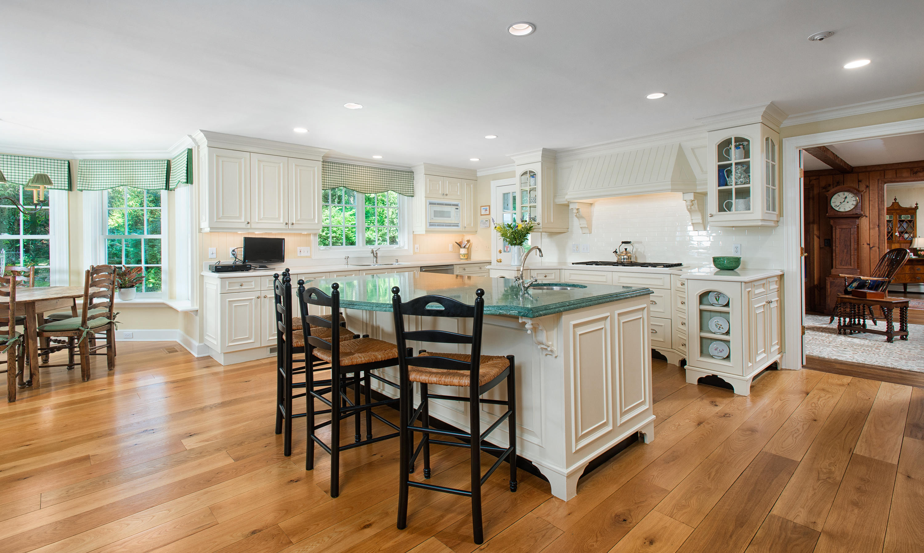 249 Nod Hill Road Wilton, CT 06897 - Photo 11 of 35 a kitchen with stainless steel appliances granite countertop wooden floor dining table and chairs
