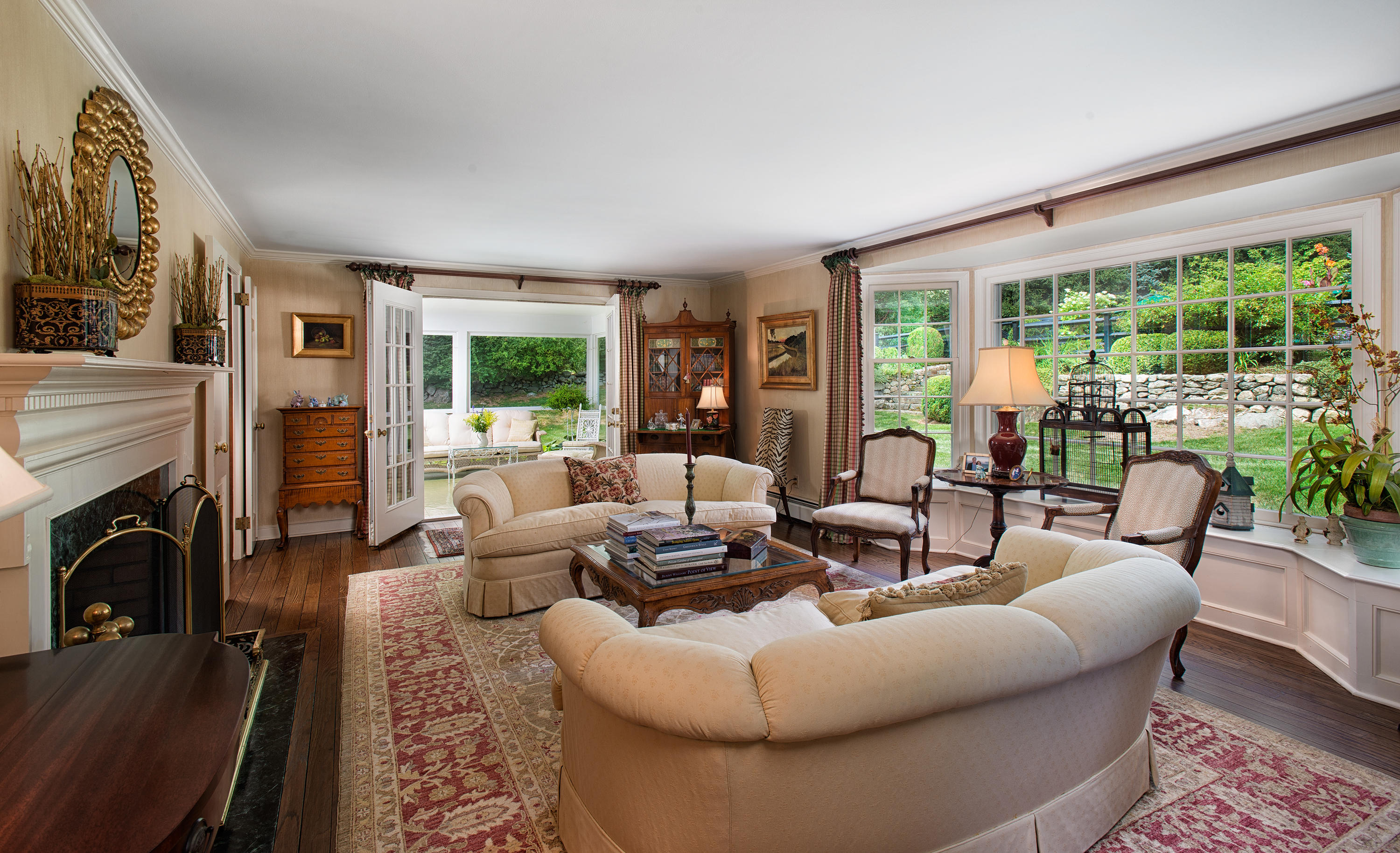 249 Nod Hill Road Wilton, CT 06897 - Photo 7 of 35 a living room with fireplace furniture and a large window