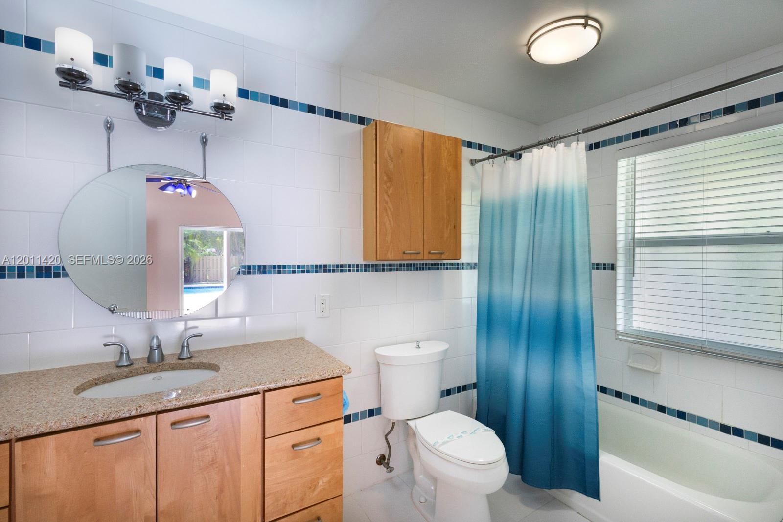 13530 Southwest 109th Terrace Miami, FL 33186 - Photo 14 of 18 a bathroom with a granite countertop sink a toilet and shower