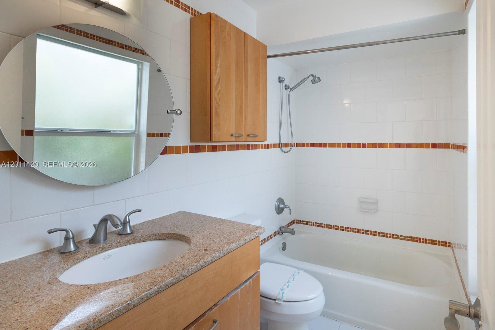13530 Southwest 109th Terrace Miami, FL 33186 - Photo 16 of 18 a bathroom with a granite countertop sink mirror vanity and toilet