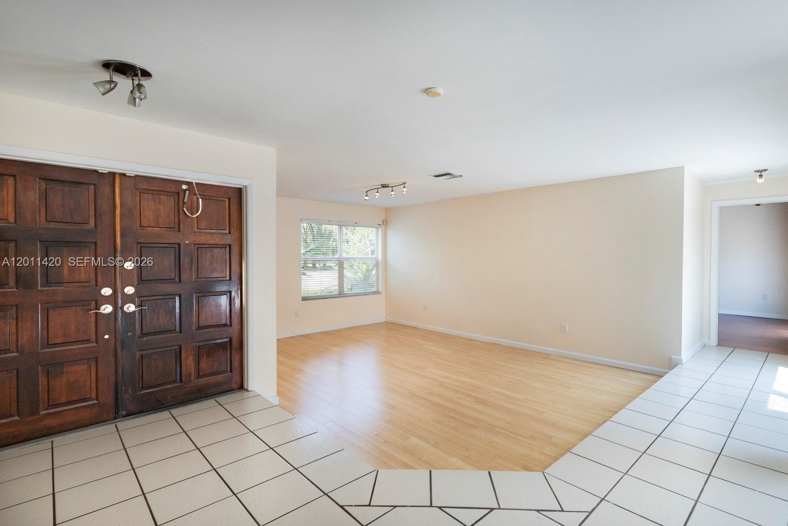 13530 Southwest 109th Terrace Miami, FL 33186 - Photo 3 of 18 a view of an empty room and window