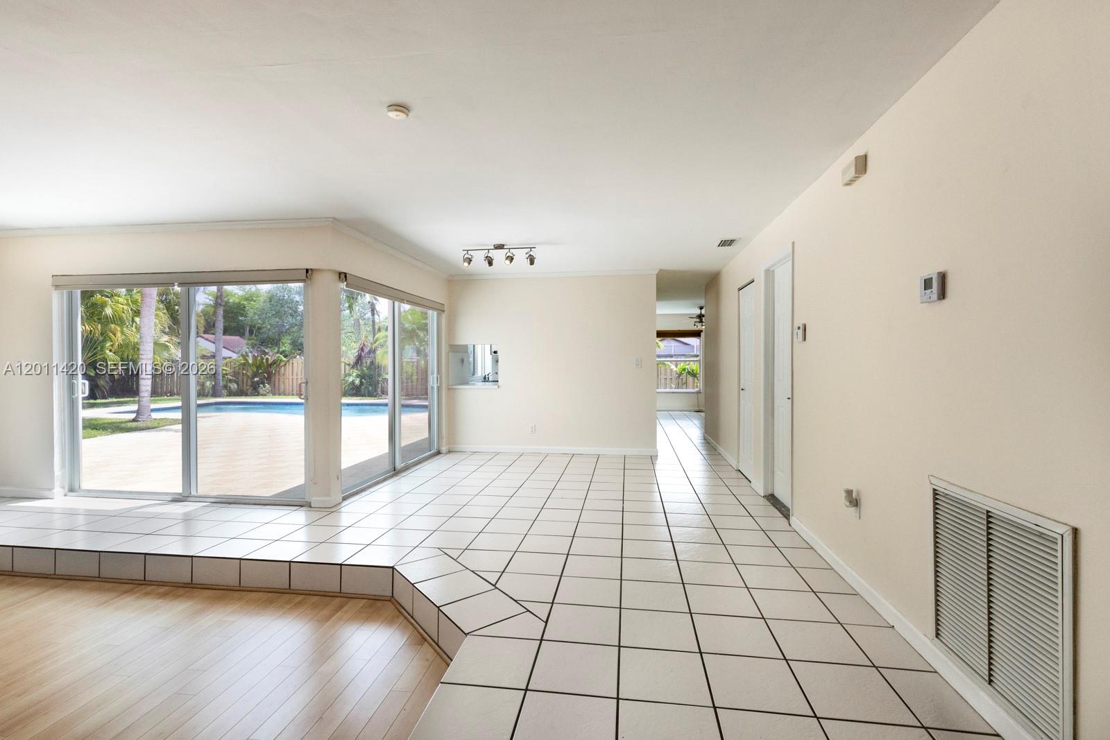 13530 Southwest 109th Terrace Miami, FL 33186 - Photo 5 of 18 a view of an empty room and window