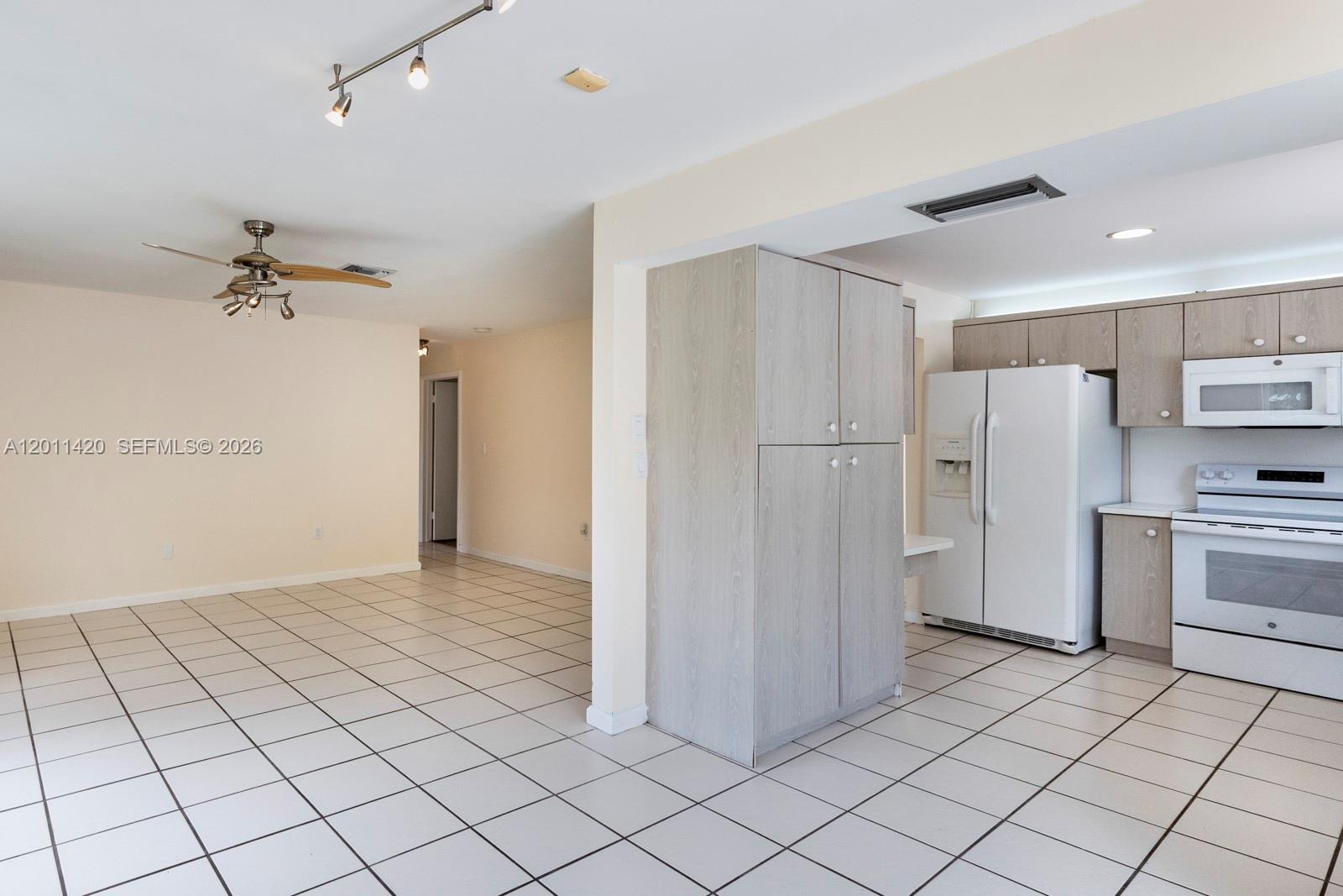 13530 Southwest 109th Terrace Miami, FL 33186 - Photo 7 of 18 a view of a kitchen with refrigerator and cabinets
