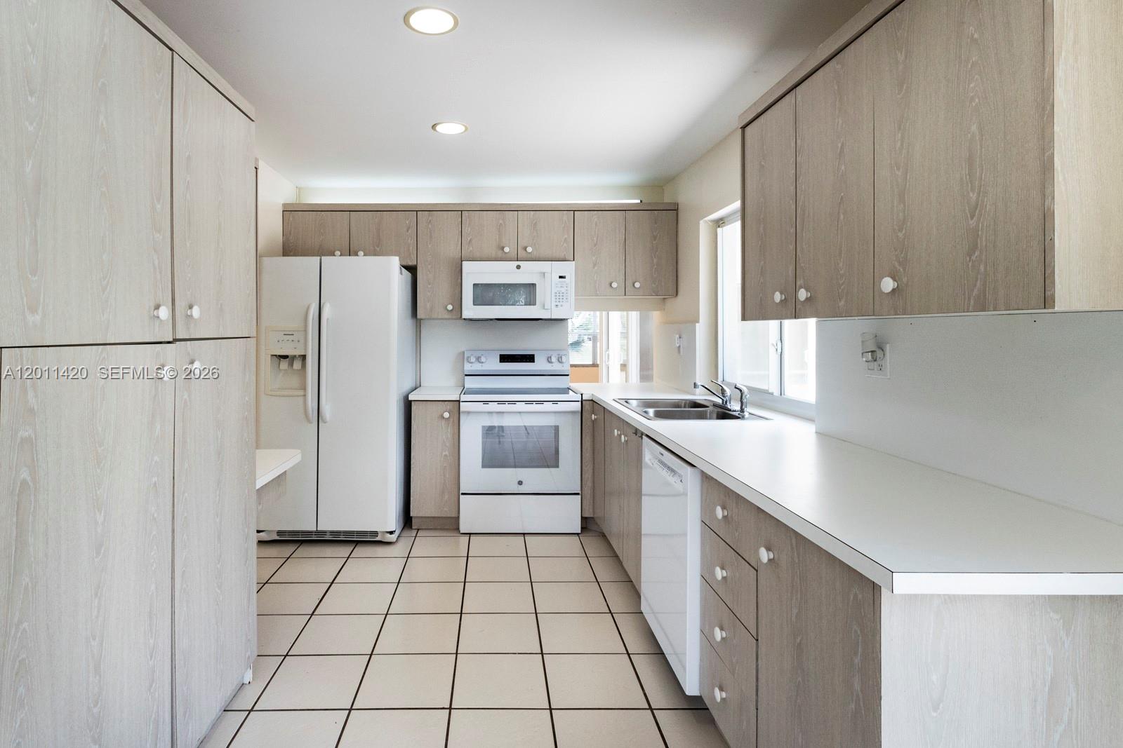 13530 Southwest 109th Terrace Miami, FL 33186 - Photo 8 of 18 a kitchen with a refrigerator a sink and dishwasher