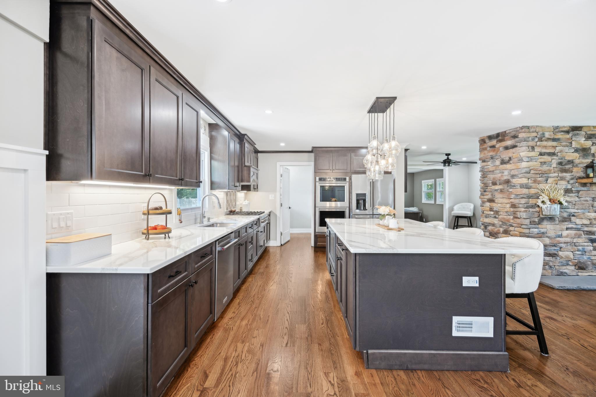 130 Silver Lake Road Bridgeton, NJ 08302 - Photo 14 of 66 a kitchen with kitchen island granite countertop wooden cabinets a sink and dishwasher