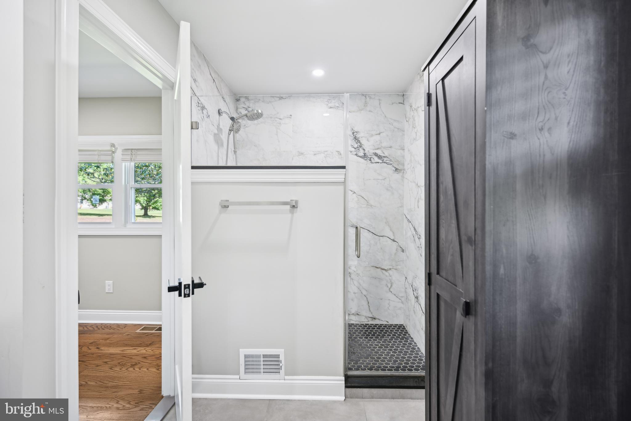130 Silver Lake Road Bridgeton, NJ 08302 - Photo 29 of 66 a bathroom with a glass shower door and a sink