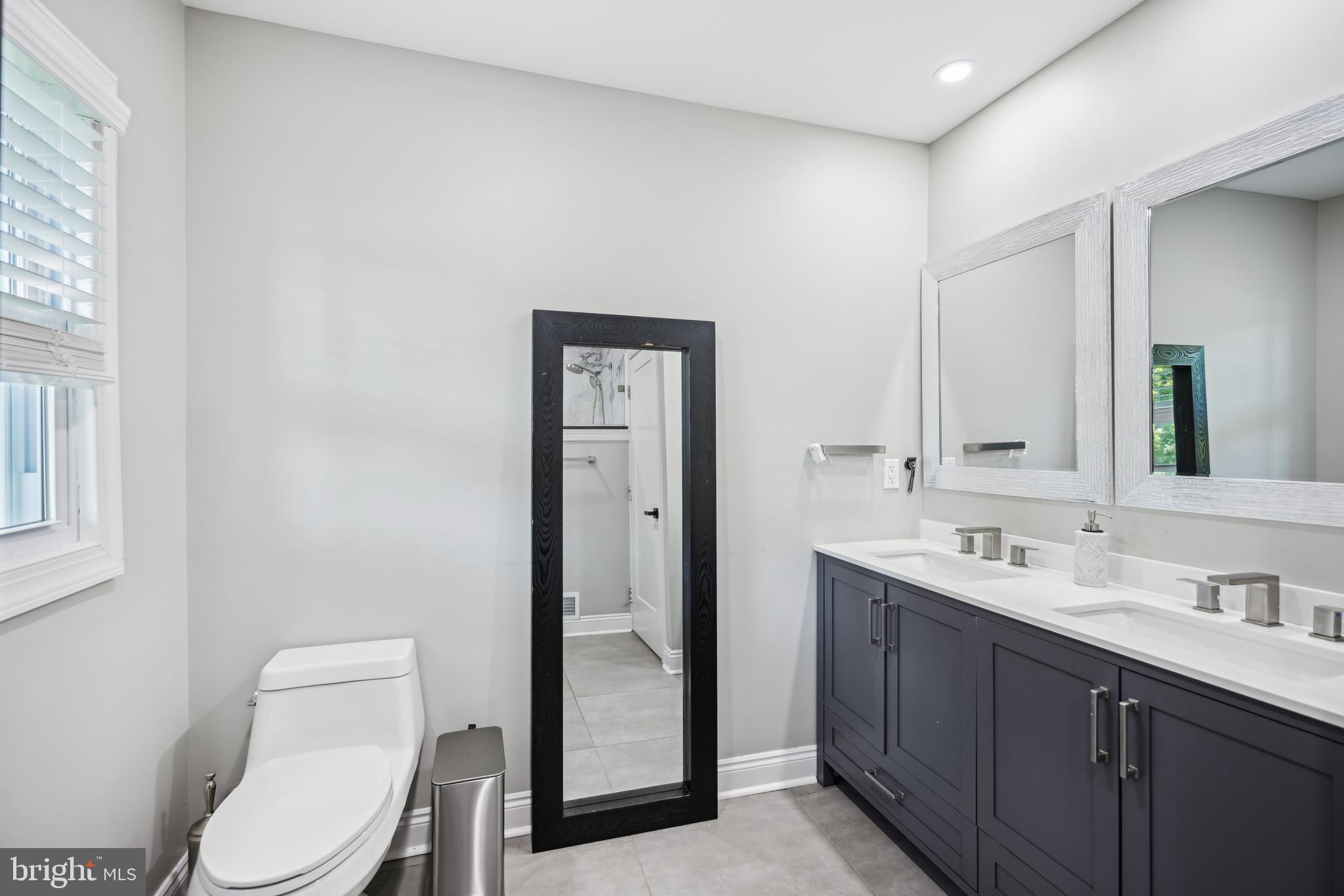 130 Silver Lake Road Bridgeton, NJ 08302 - Photo 31 of 66 a bathroom with a toilet a sink a mirror and vanity