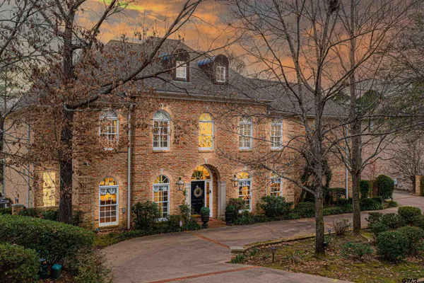 a front view of a building with tree s