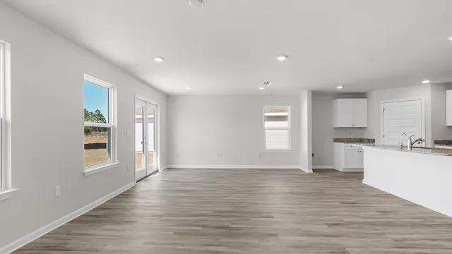 a view of kitchen with wooden floor and windows