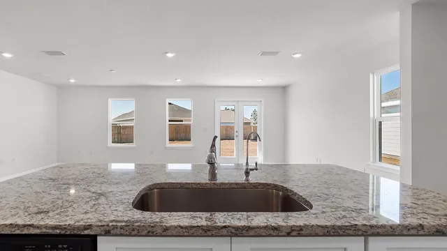 a kitchen with stainless steel appliances granite countertop a sink and cabinets