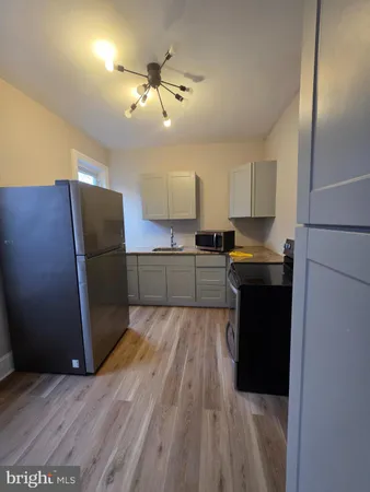 a kitchen with a refrigerator and cabinets