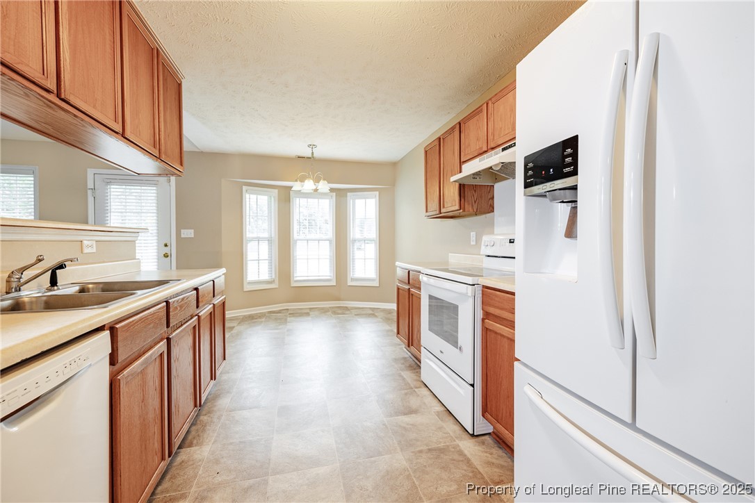 112 Partridge Road Fayetteville, NC 28306 - Photo 12 of 29 a kitchen with stainless steel appliances granite countertop a refrigerator and a stove top oven