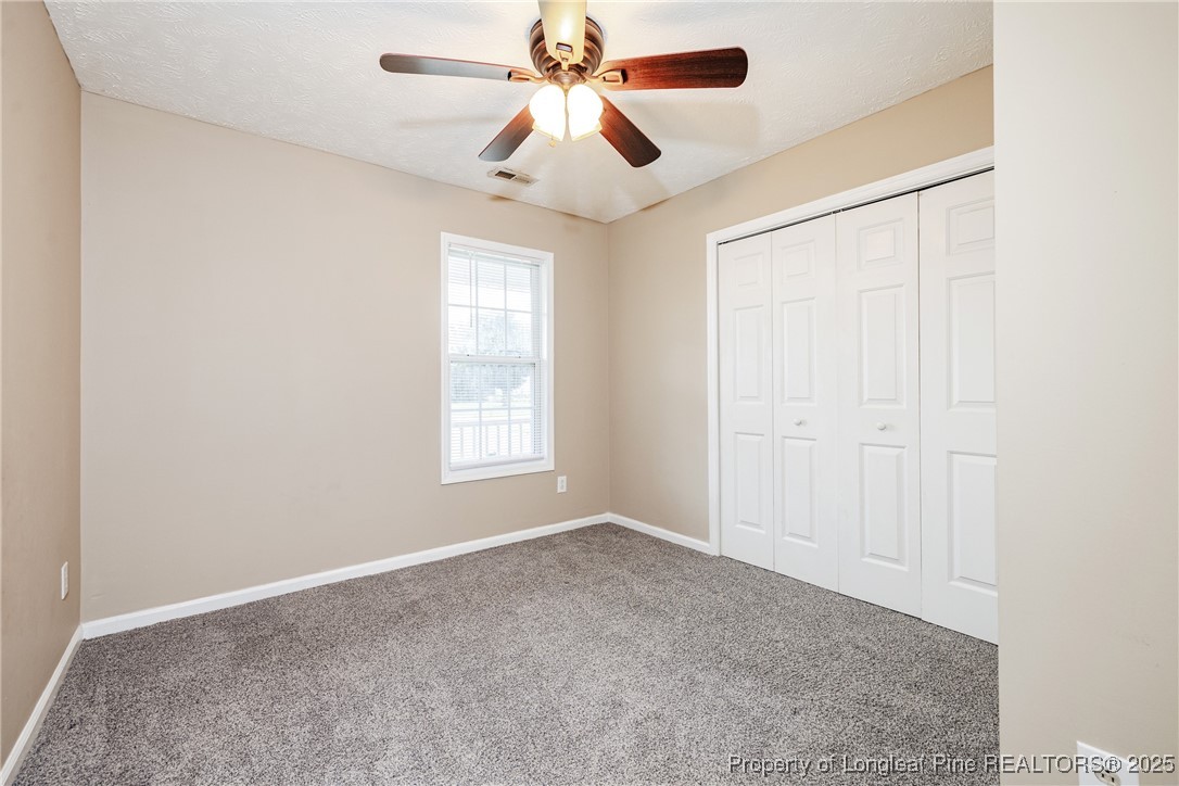 112 Partridge Road Fayetteville, NC 28306 - Photo 15 of 29 an empty room with windows and fan