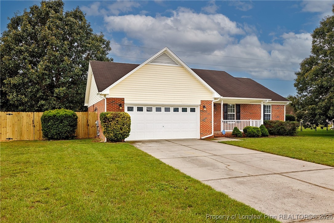 112 Partridge Road Fayetteville, NC 28306 - Photo 3 of 29 a view of a house with a yard and garage