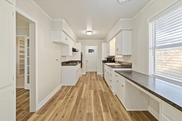 a view of empty room with wooden floor and fireplace