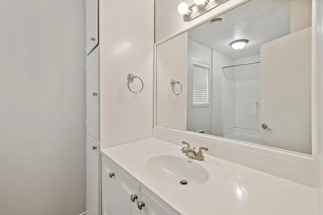 a view of room with a ceiling fan and window