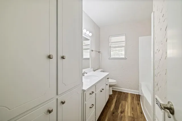 an empty room with closet and a ceiling fan