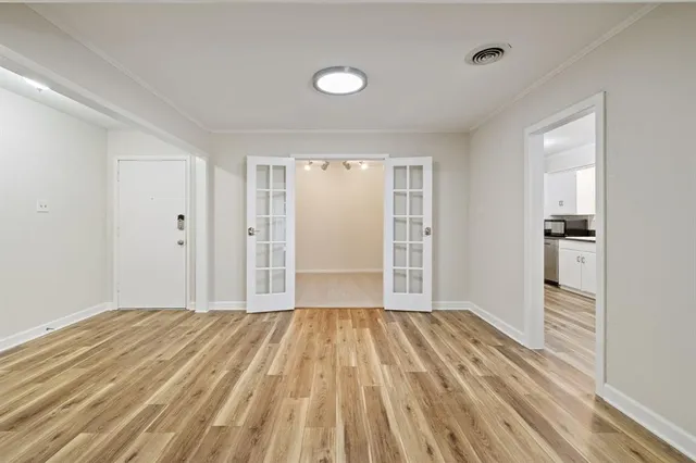 wooden floor in an empty room with a window