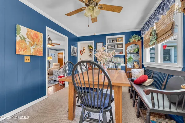 a kitchen with stainless steel appliances granite countertop a sink dishwasher a dining table and chairs with wooden floor