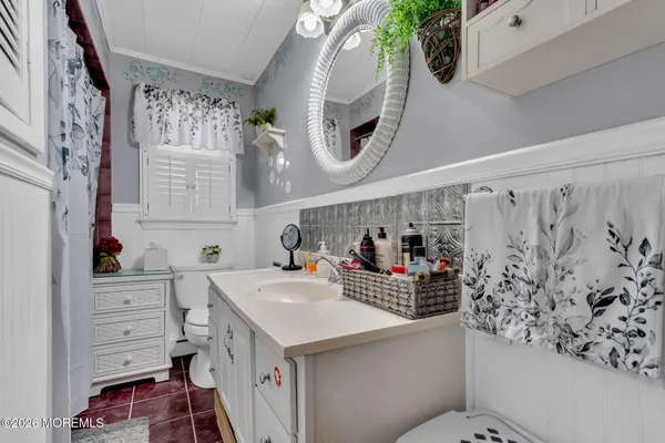 a bathroom with a sink mirror and a bathtub