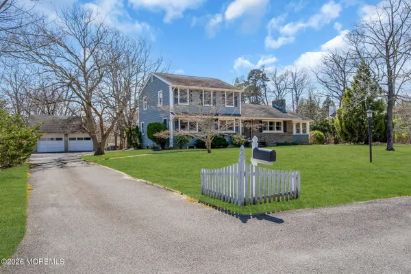 a view of house with outdoor space and garden