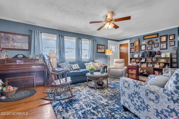 a living room with furniture fireplace and a window