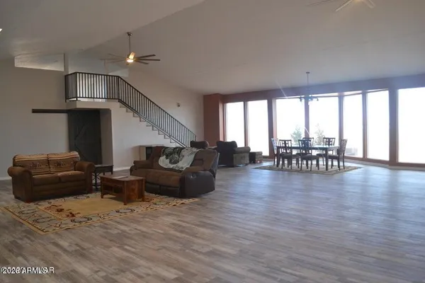 a living room with furniture and a wooden floor