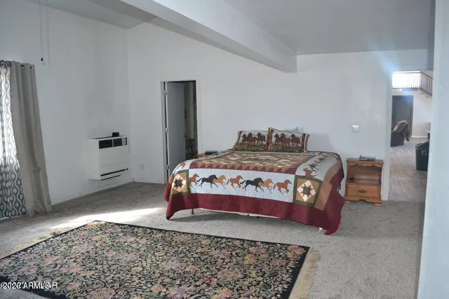 a bedroom with a bed and flat screen tv