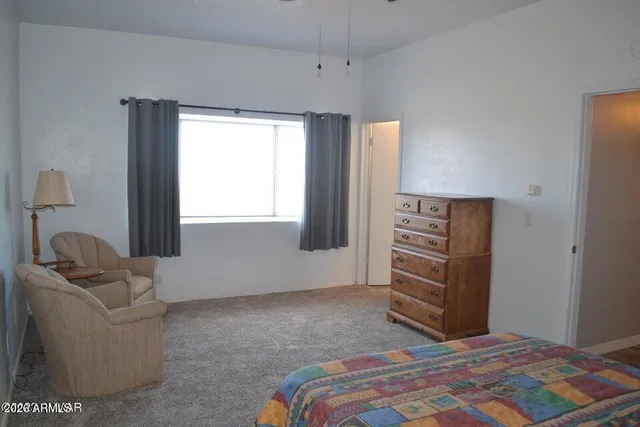 a bedroom with a bed and a window