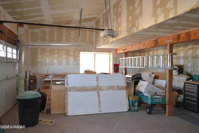 a spacious bedroom with a bed and a window