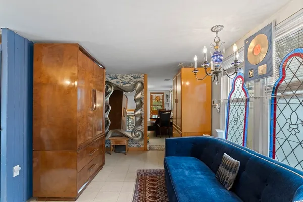 a living room with furniture and a chandelier